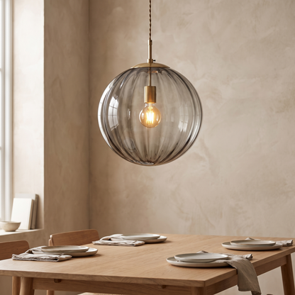 Glass ball pendant light above a dining table
